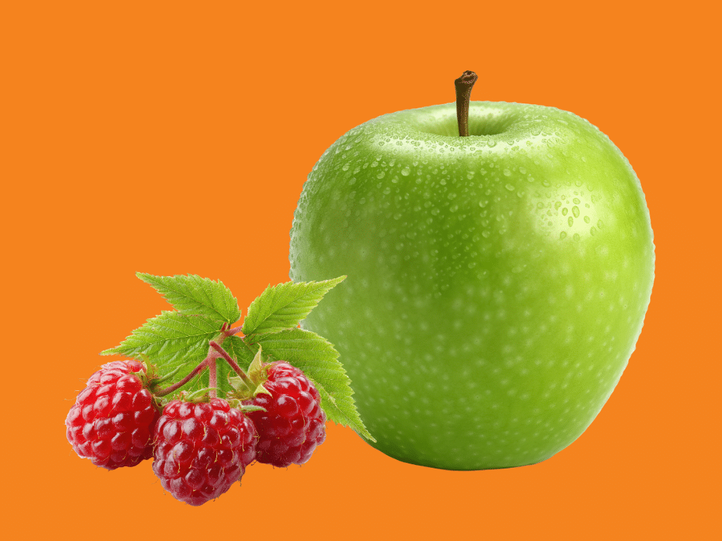 Image of granny smith apple and small bunch of raspberries on orange background.